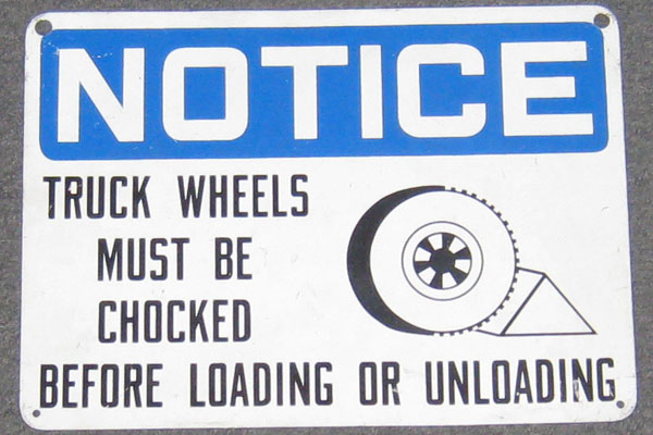 Sign-Notice truck wheels must be chocked before loading or unloading, stock number S-0019
