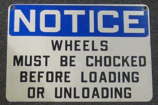 Sign-Notice Truck Wheels Must Be Chocked Before Loading and Unloading, stock number S-0431