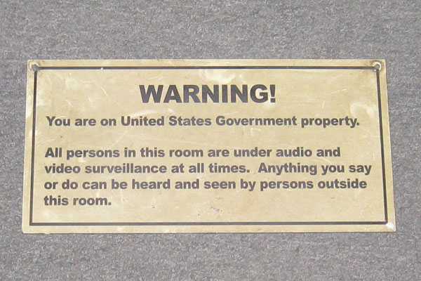 Sign-Warning! You Are On Government Property... Tan laminate w/ black lettering, stock number S-1939