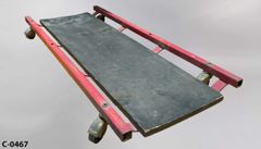 Creeper, red metal frame, black wooden plank, no padding, 40" x 16½", stock number C-0467