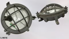 Light, wall mount, round grey metal w/ glass lens & guard; 10"diax6"t, stock number L-0616