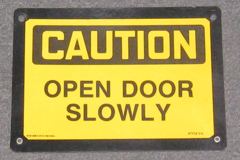 Sign-Caution open door slowly, plastic w/ black border, blk/yellow, stock number S-0287