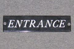 Sign-Entrance, blk/wht, metal, 10"w x 2½"t, stock number S-0303