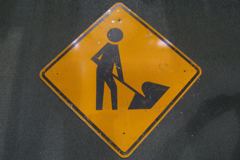 Sign-symbol of man working, metal, black/orange, 41"w x 41"t (30"x30", stock number S-1059