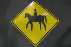 Sign-symbol of person riding a horse, metal, ylw/blk, 41"w x 41"t, stock number S-1063