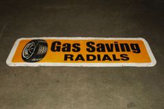 Sign-Gas Saving Radials w/ picture of tire on wheel, metal, stock number S-1073