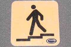 Sign-symbol of man walking downstairs, foamcore board, black/yellow, stock number S-1243