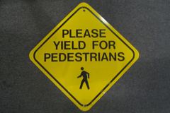 Sign-Please Yield For Pedestrians, w/ symbol of walking man, metal, stock number S-1250