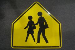 Sign-(symbol of men & women crossing) triangular, 30" x 30", stock number S-1302