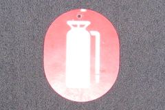 Sign-(symbol of a fire extinguisher), oval, red/wht, plastic, 5"w x, stock number S-1336