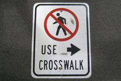 Sign-Use Crosswalk, w/ crossed out symbol of figure walking, stock number S-1446