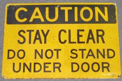 Sign-Caution Stay Clear Do Not Stand Under Door, yellow/blk,metal, stock number S-1538
