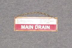 Sign-Main Drain, U.C.S Plumbing Dept. Ext. 7-1611, 24 Hour# Security, stock number S-2242