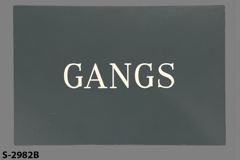 Sign-Gangs, grey/wht, plastic, 12"w x 8"t, stock number S-2982b